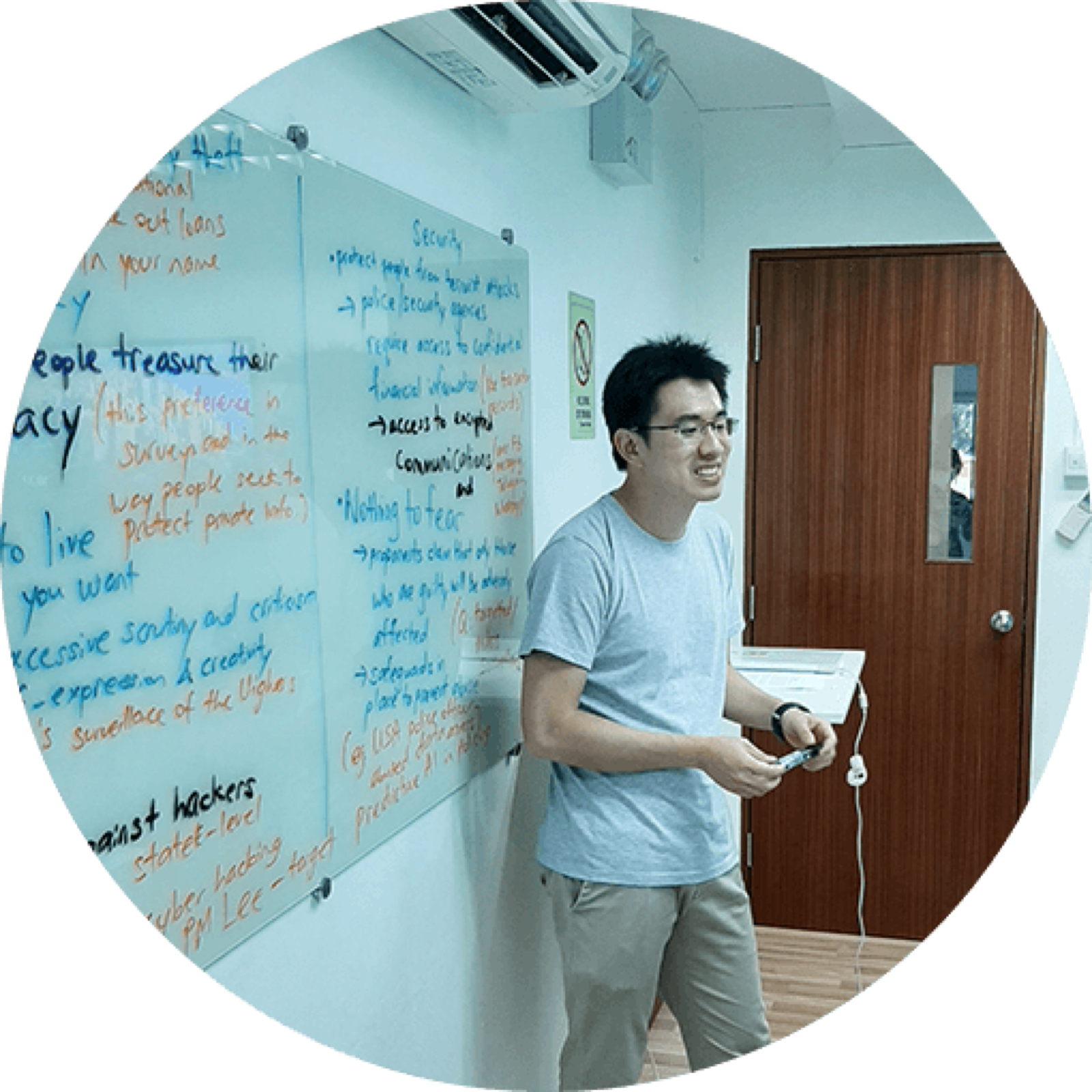 Tutor teaching at a whiteboard at My Mustard Seed